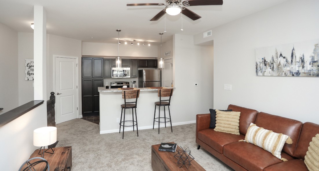 the living room and kitchen area of a new apartment at The Alpine Studios