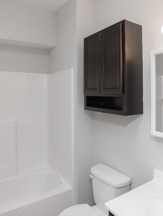 a bathroom with a toilet, sink and shower at The Alpine Studios