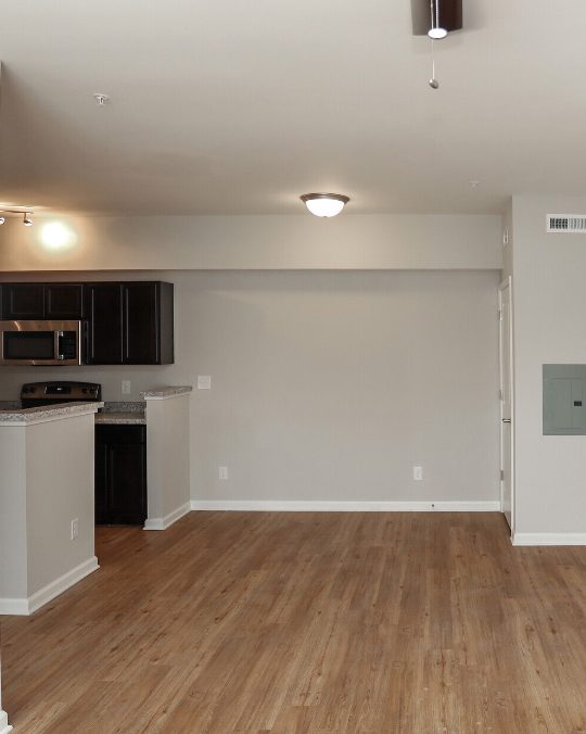 an empty room with hardwood floors and a white ceiling at The Alpine Studios