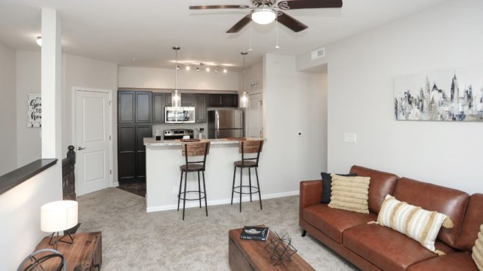 the living room and kitchen area of a new apartment at The Alpine Studios