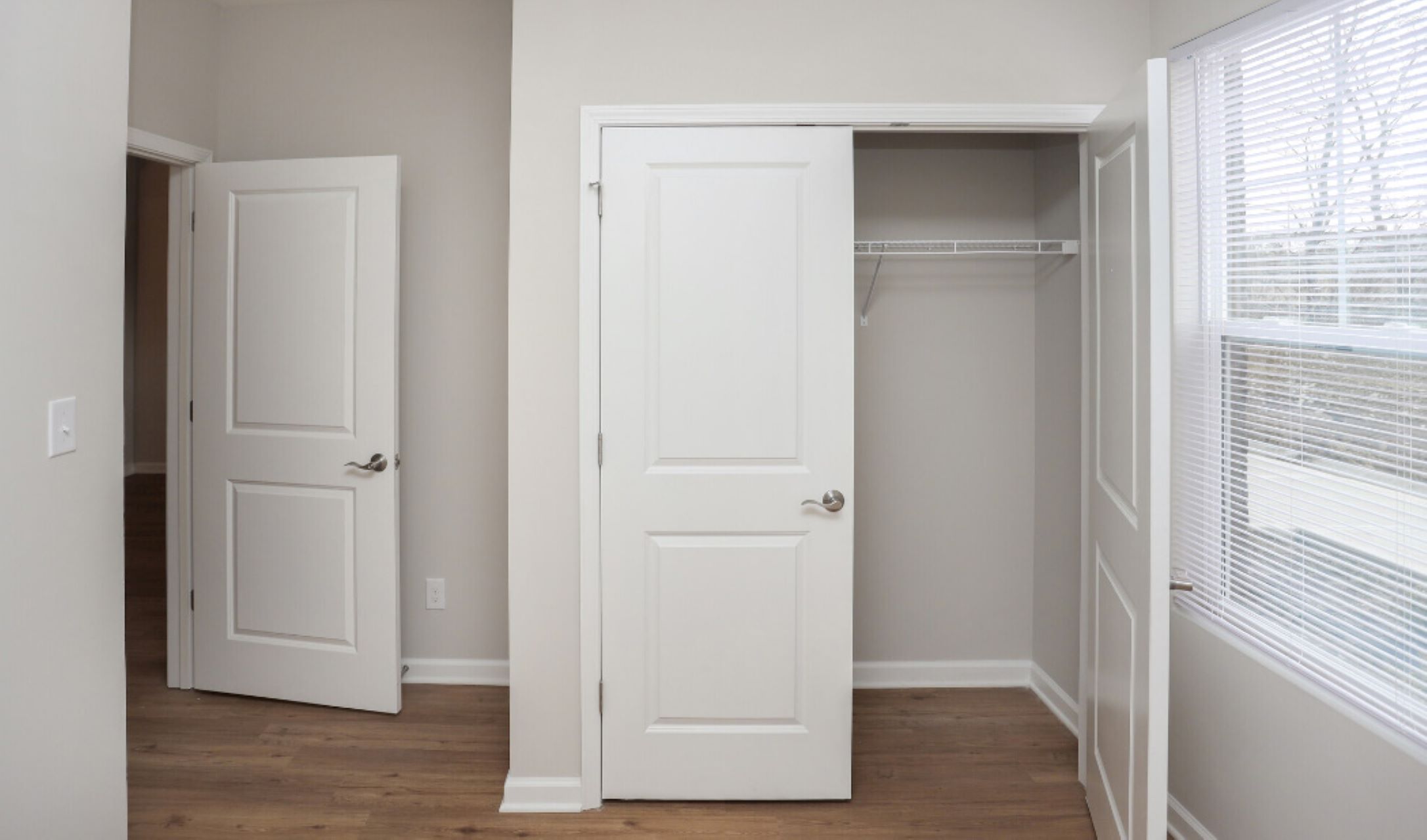 a white closet with two doors and a closet door at The Alpine Studios