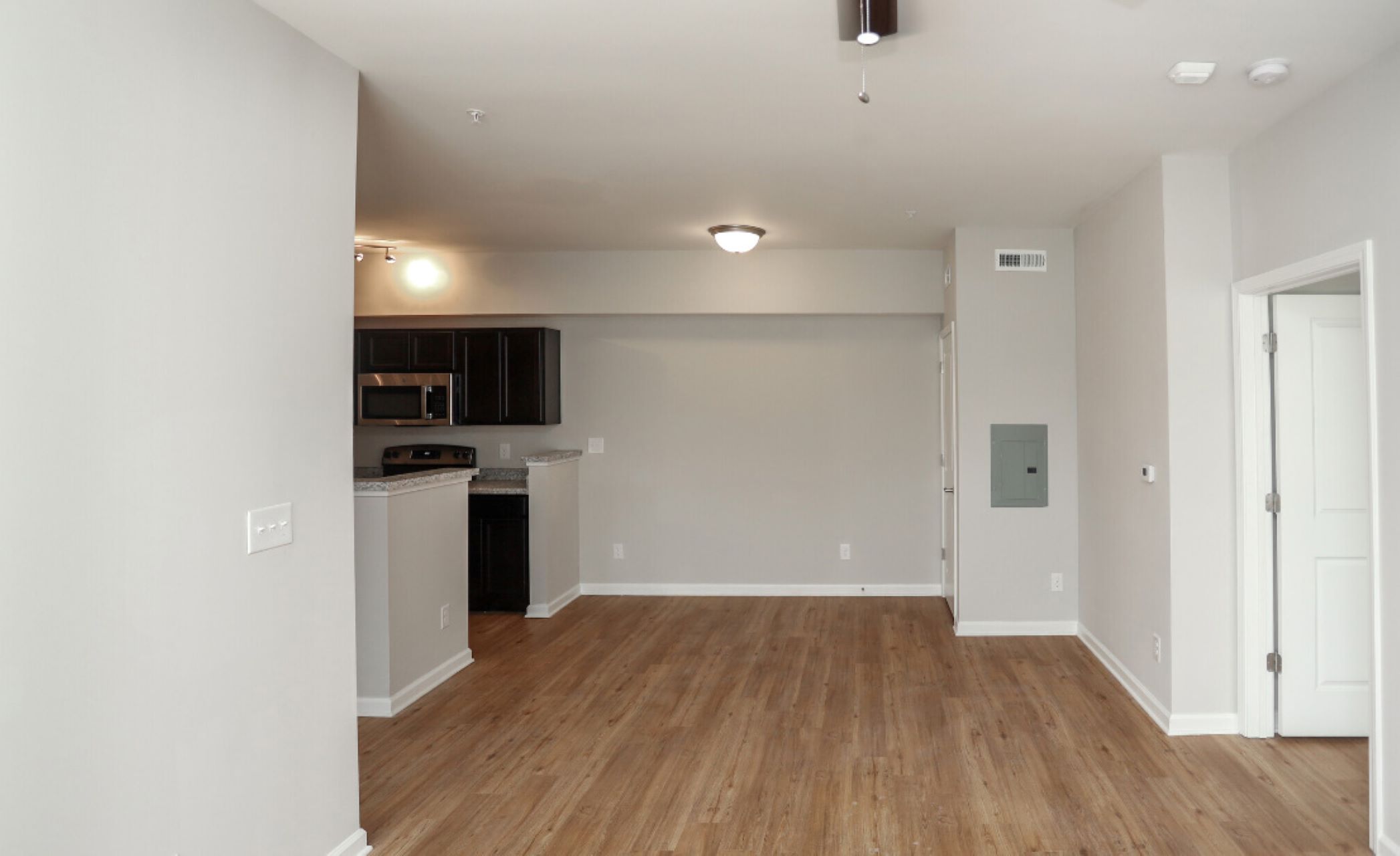 empty room with hardwood floors and white walls at The Alpine Studios