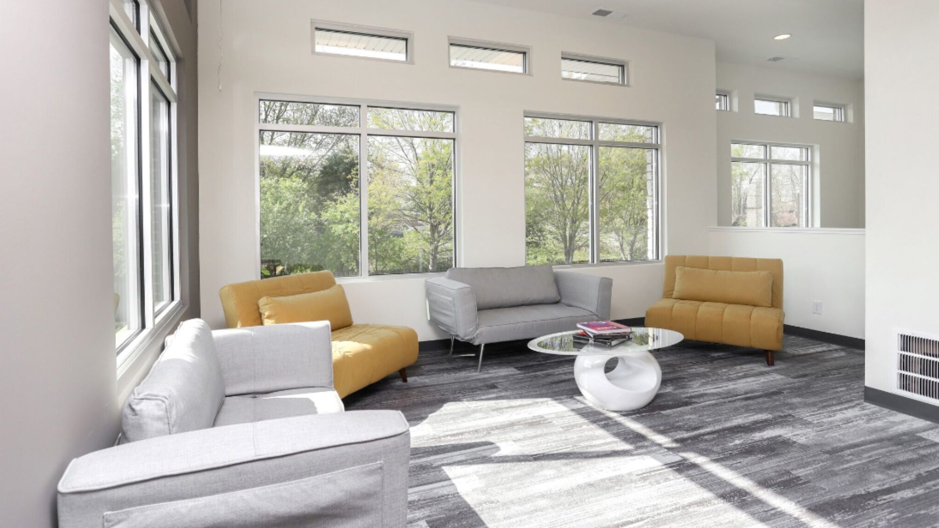 a clean and modern living room with couches and chairs at The Alpine Studios